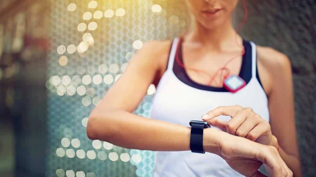 woman checking her smartwatch for running